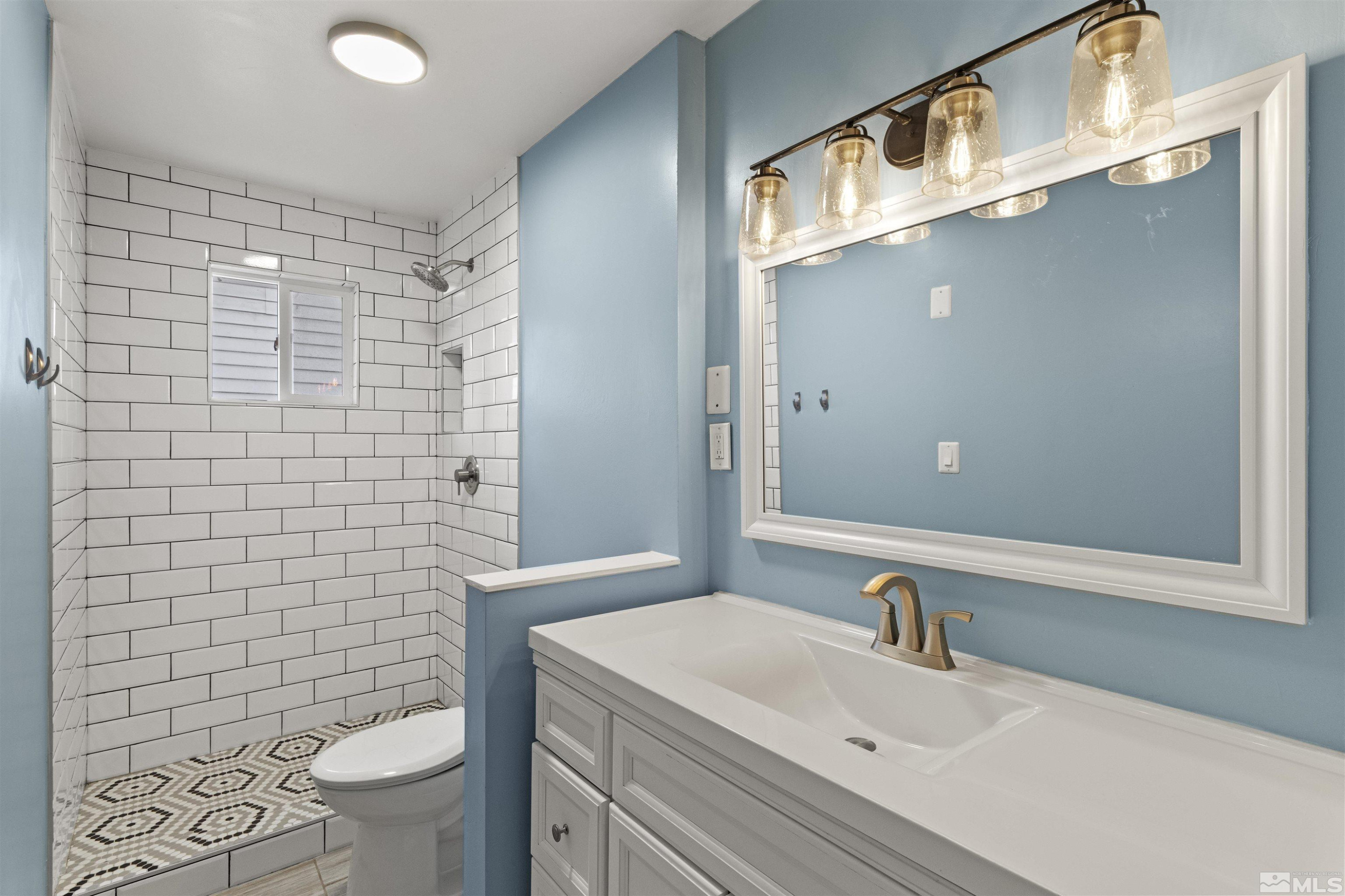1430 Foster Drive Reno, NV 89509 - Photo 18 of 25 a bathroom with a sink a toilet and shower