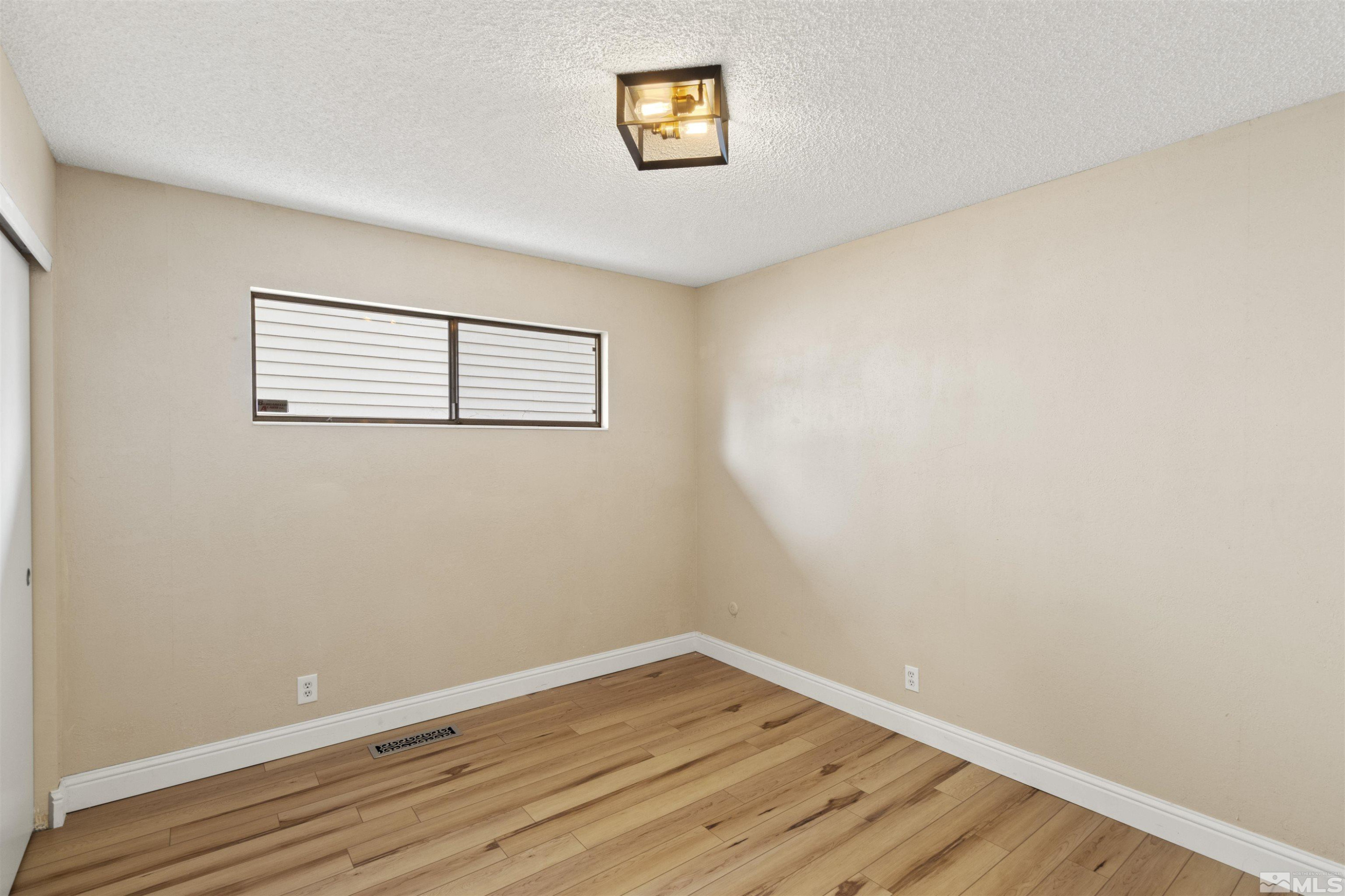 1430 Foster Drive Reno, NV 89509 - Photo 19 of 25 a view of a room with wooden floor and window