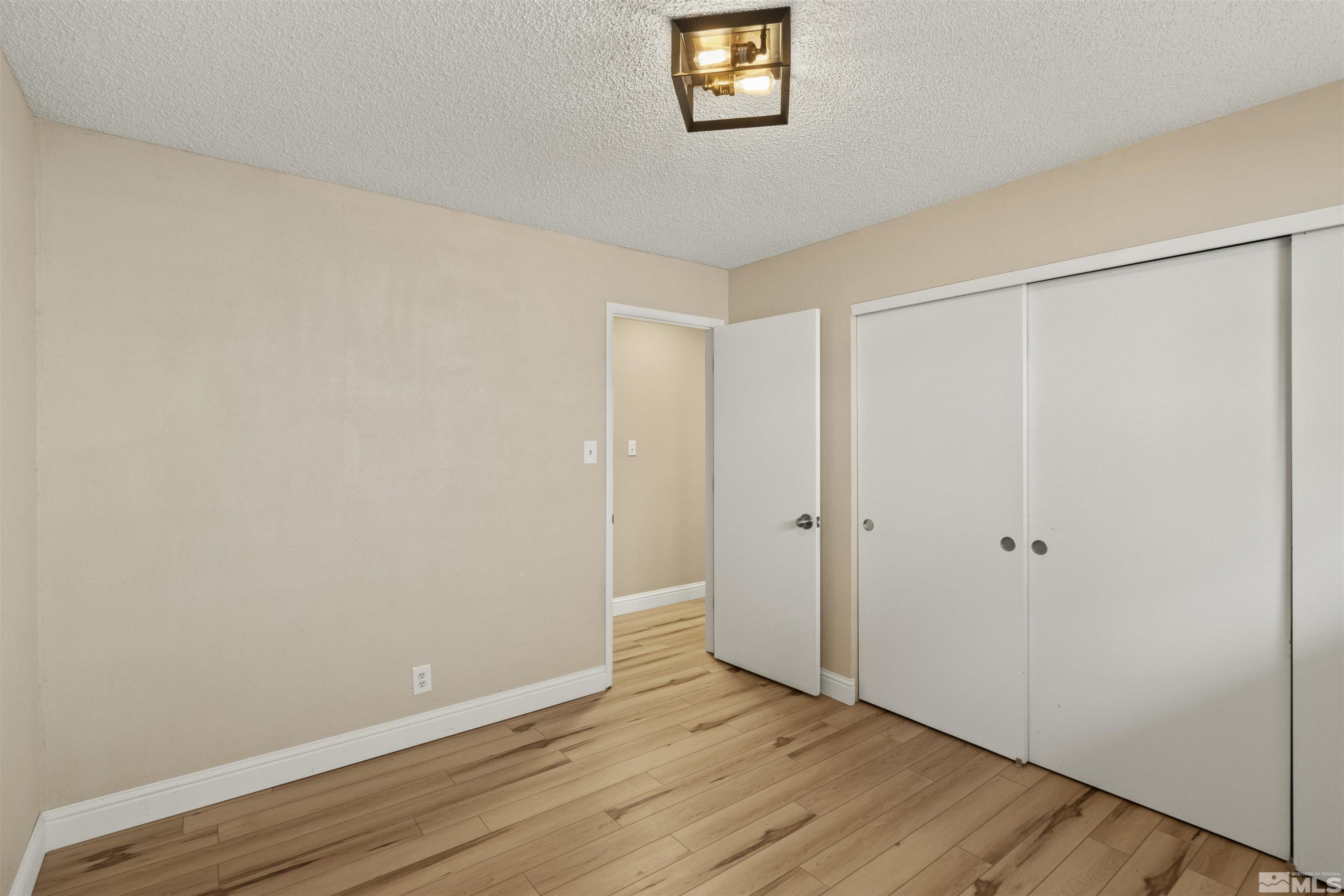 1430 Foster Drive Reno, NV 89509 - Photo 20 of 25 a view of an empty room with wooden floor and a window