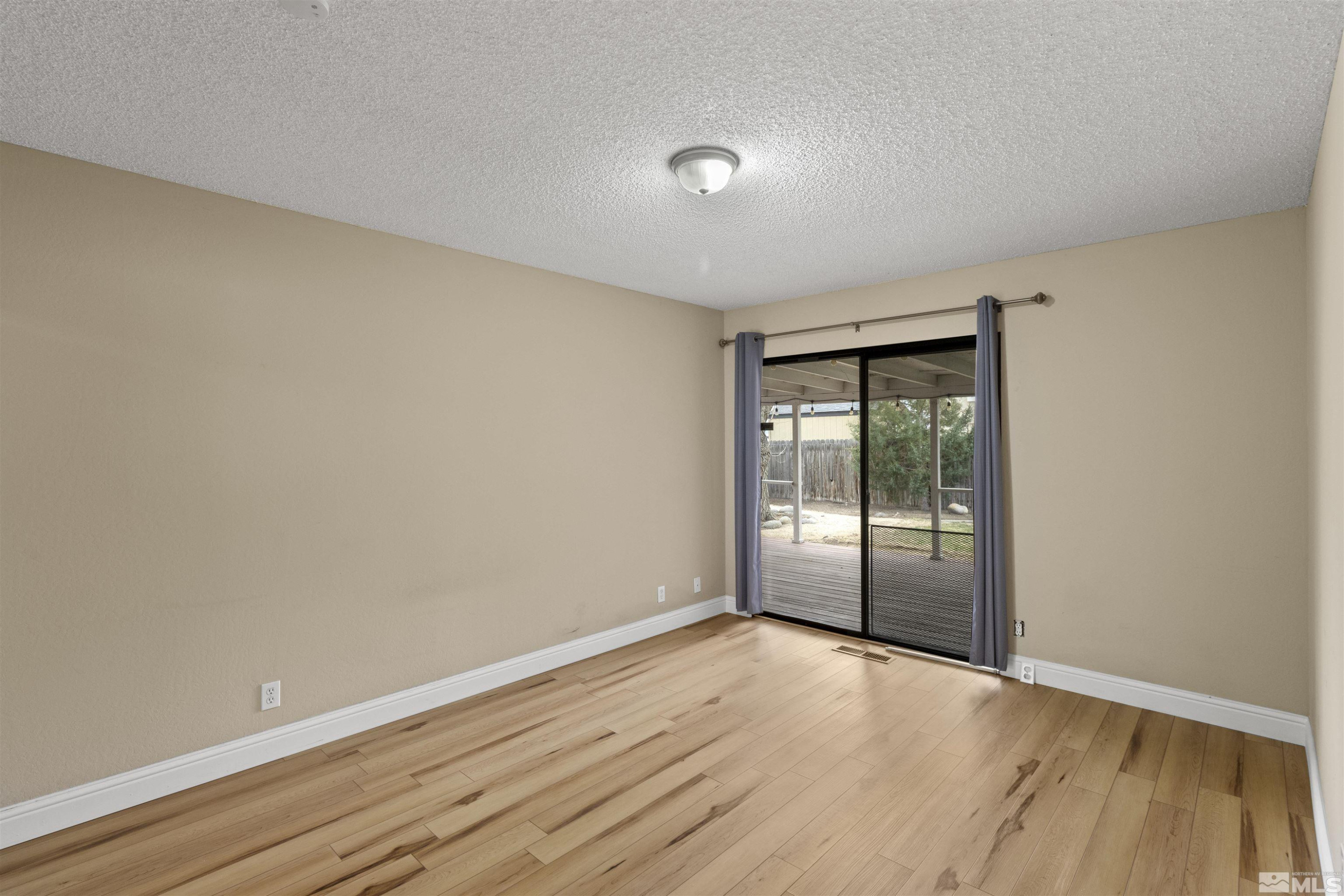 1430 Foster Drive Reno, NV 89509 - Photo 21 of 25 wooden floor in an empty room with a window