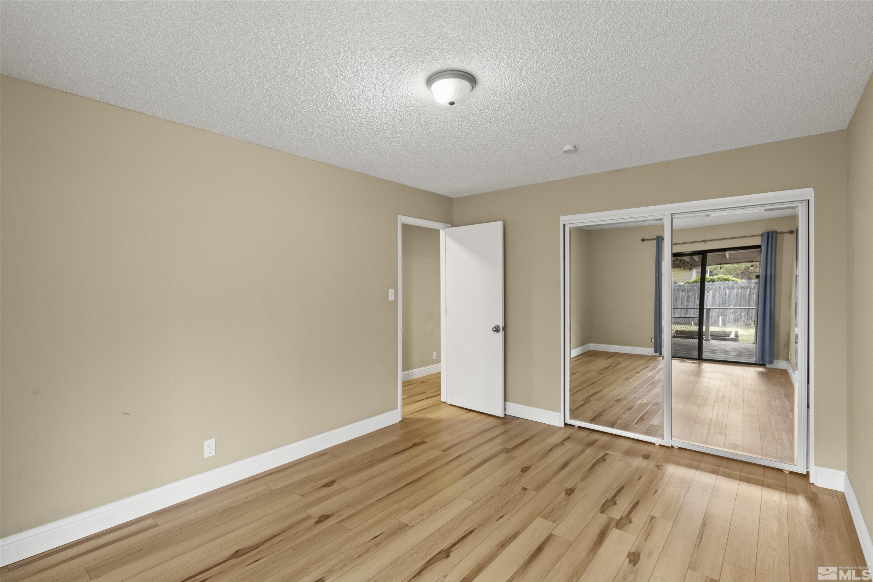 1430 Foster Drive Reno, NV 89509 - Photo 22 of 25 an empty room with wooden floor and windows