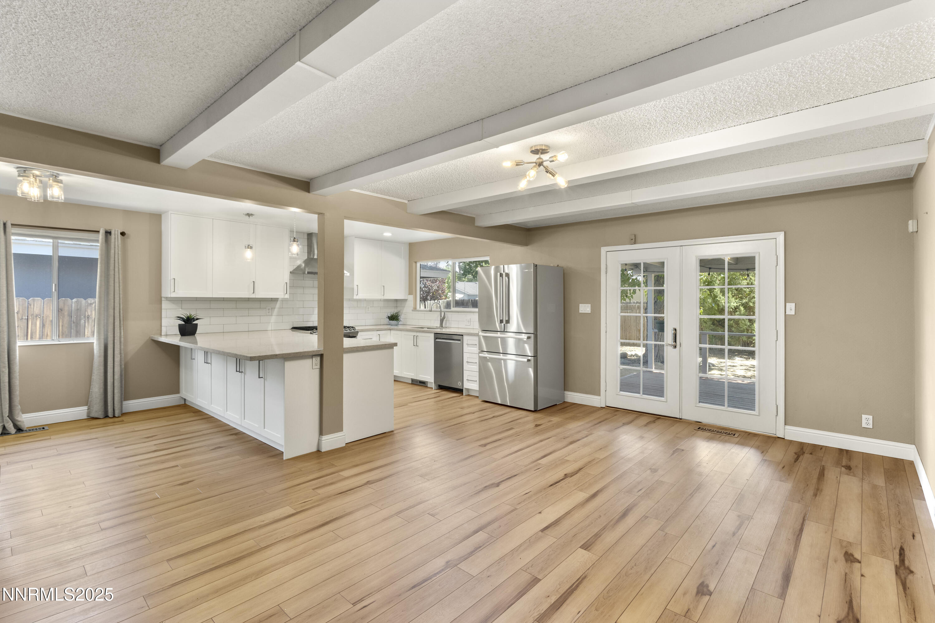 1430 Foster Drive Reno, NV 89509 - Photo 3 of 25 a large kitchen with wooden floors and stainless steel appliances