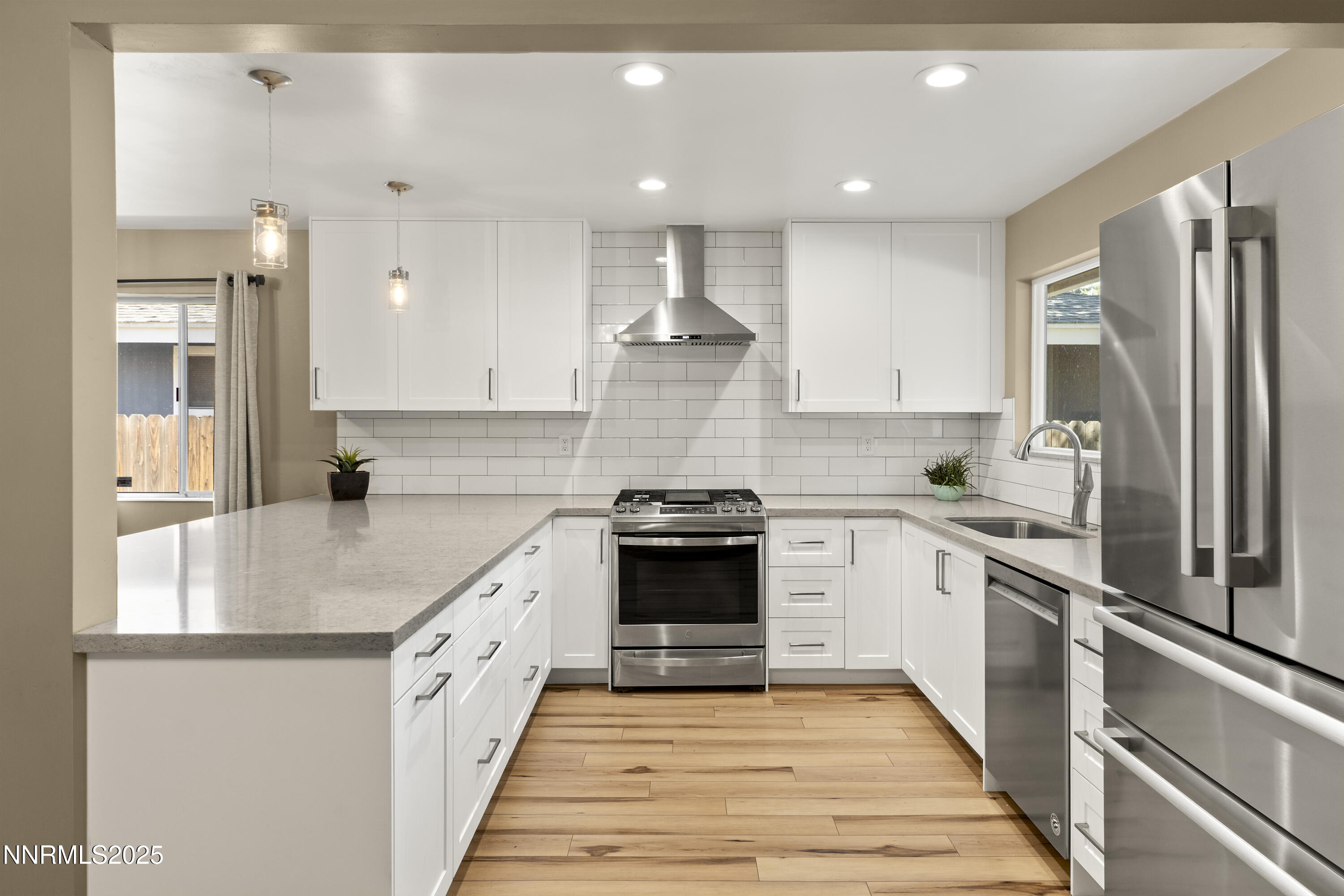 1430 Foster Drive Reno, NV 89509 - Photo 5 of 25 a large kitchen with stainless steel appliances granite countertop a stove and a refrigerator