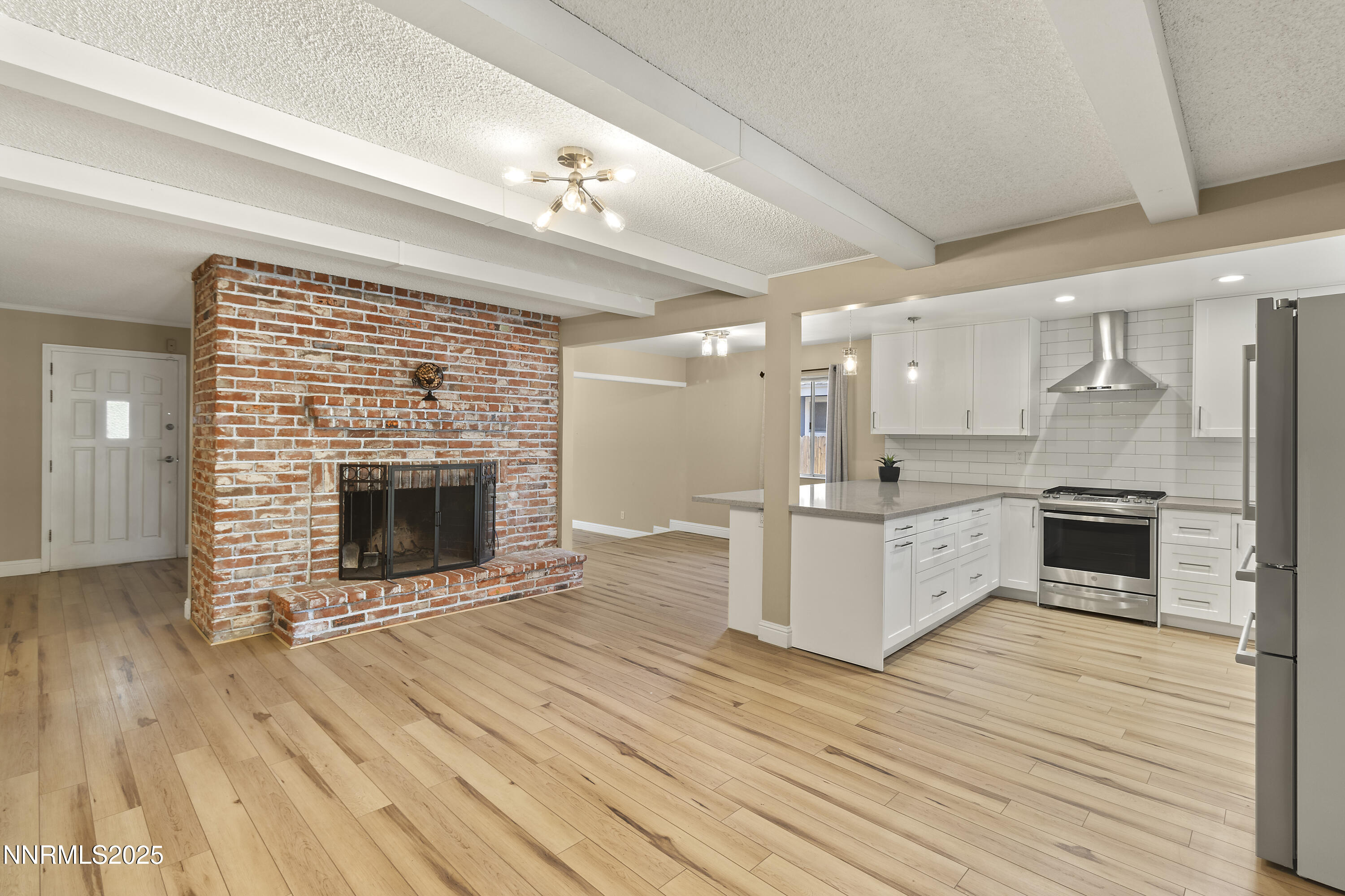 1430 Foster Drive Reno, NV 89509 - Photo 8 of 25 a large kitchen with cabinets wooden floor and stainless steel appliances