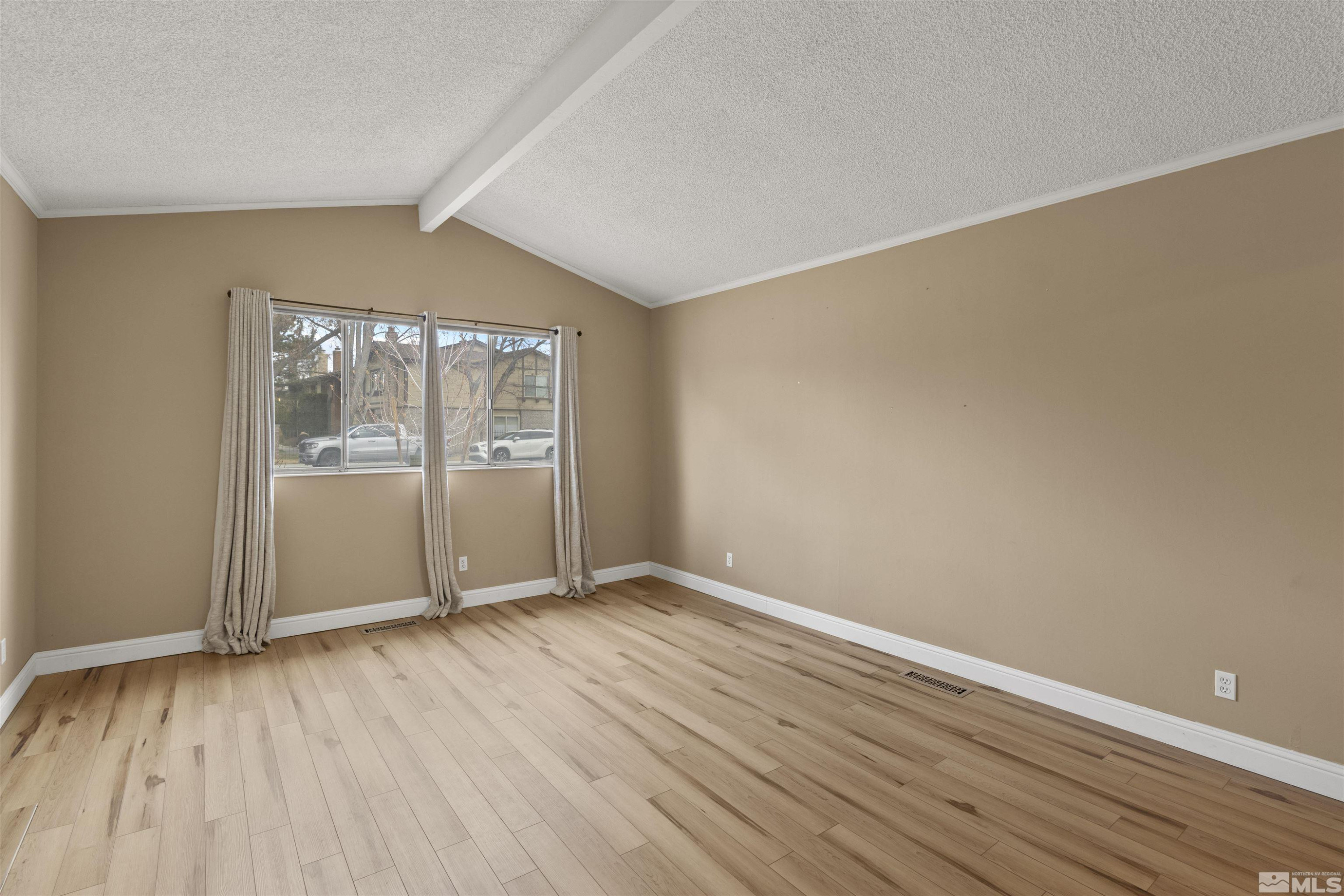 1430 Foster Drive Reno, NV 89509 - Photo 10 of 25 an empty room with wooden floor and windows