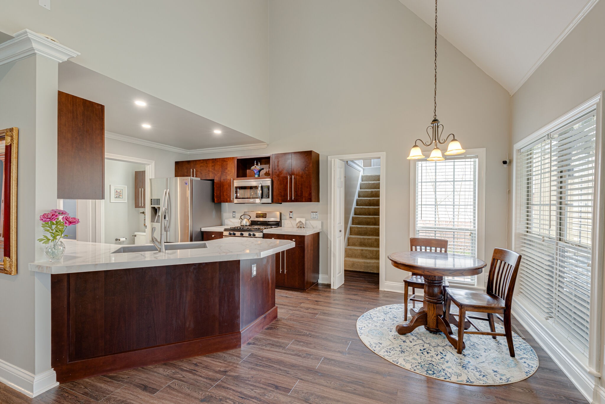 1906 Kent Lane Spring Hill, TN 37174 - Photo 11 of 39 a kitchen with kitchen island a dining table chairs stainless steel appliances and cabinets