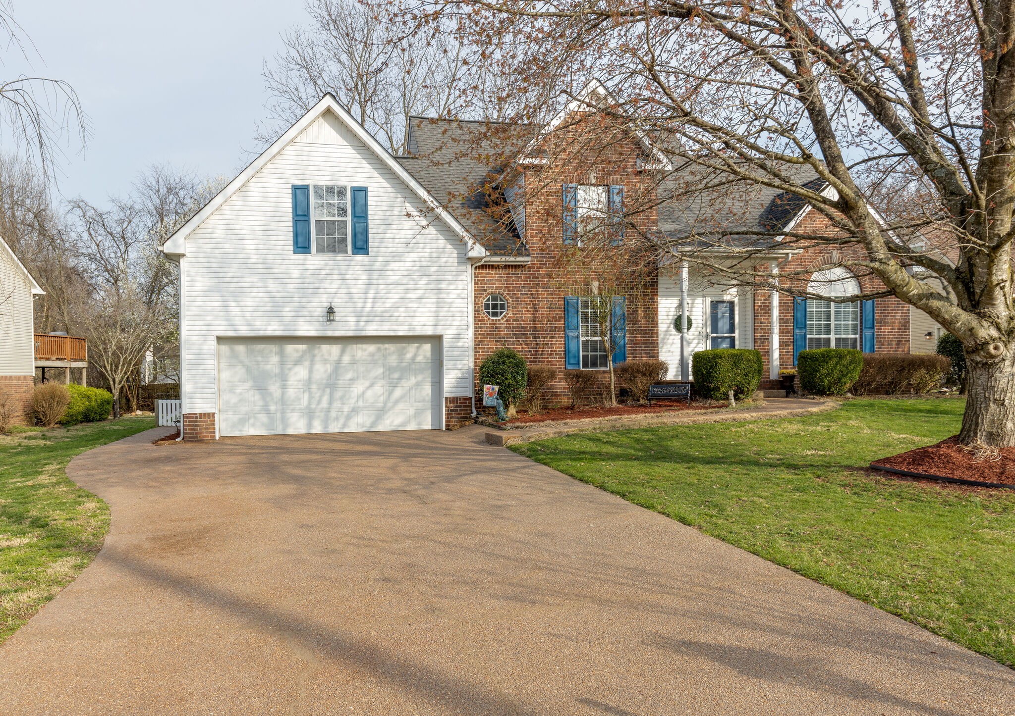 1906 Kent Lane Spring Hill, TN 37174 - Photo 3 of 39 a view of a white house with a big yard and large trees