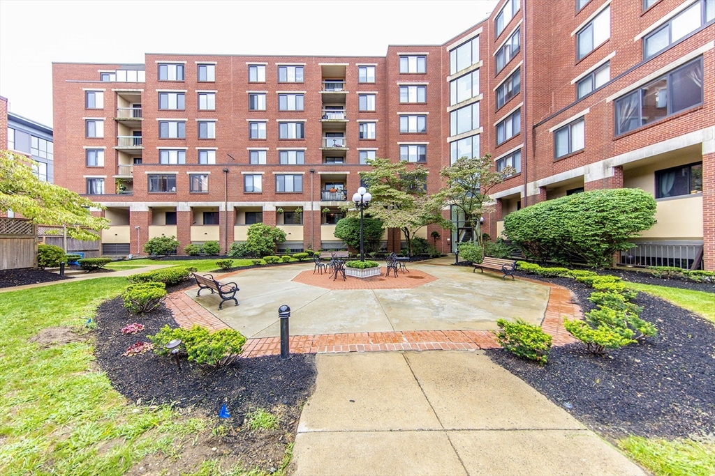 85 Brainerd Road, Unit 503 Boston, MA 02134 - Photo 16 of 21 a view of a building with garden
