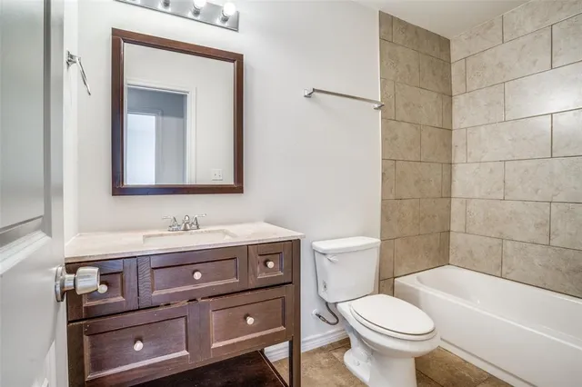 a bathroom with a toilet a sink and bathtub