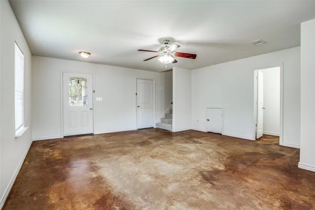 a view of empty room with ceiling fan