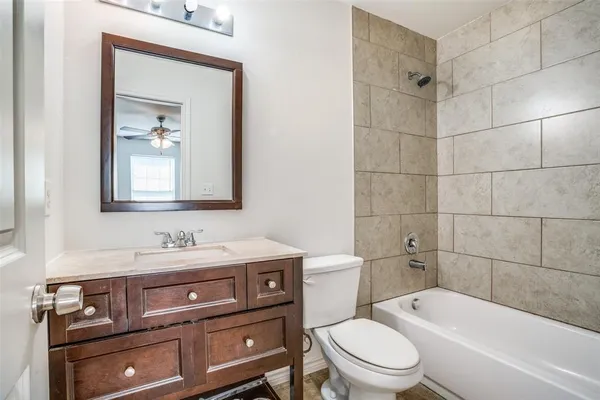 a bathroom with a sink a toilet and bathtub