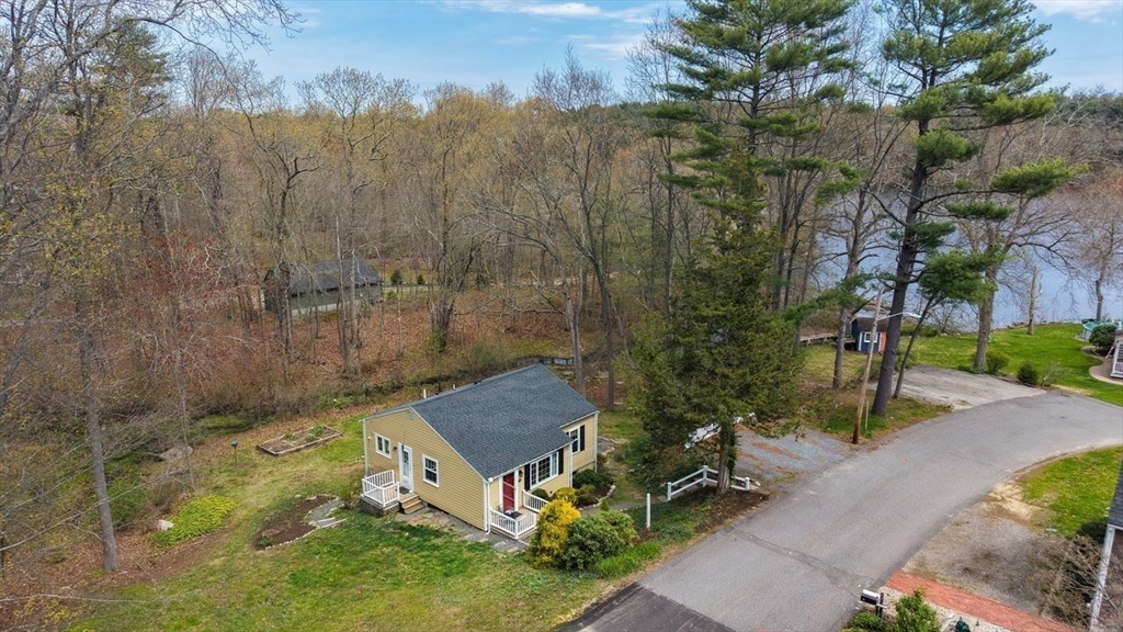 15 Leigh Road Norwell, MA 02061 - Photo 28 of 34 a view of a garden with a bench in front of the house