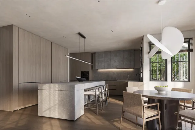 a kitchen with a table chairs microwave and cabinets