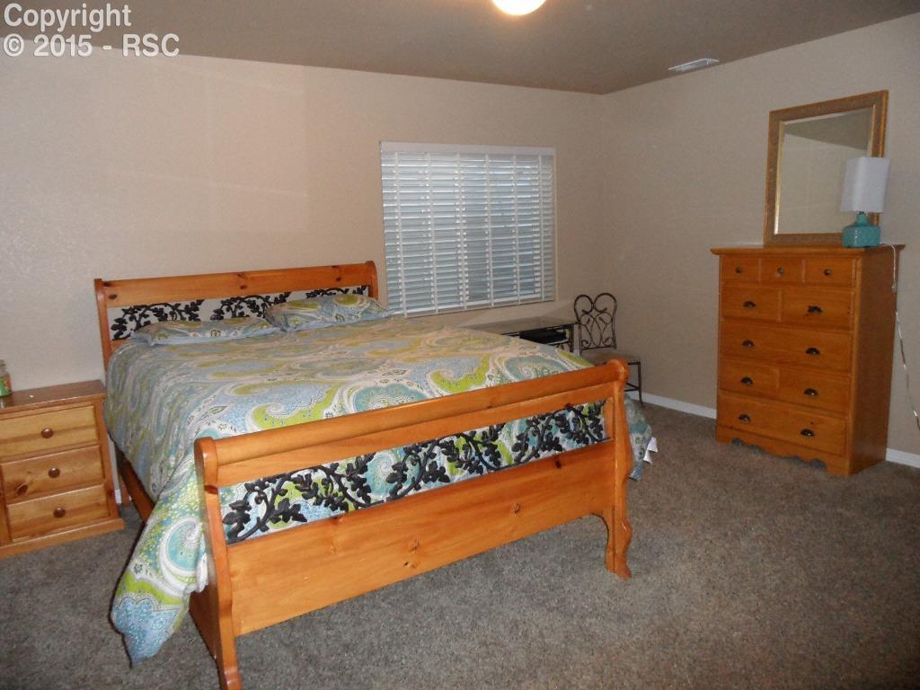 2275 Reed Grass Way Colorado Springs, CO 80915 - Photo 20 of 24 Bedroom #4 again w/ queen bed to show scale