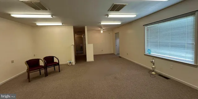 a view of a livingroom with a chair and wooden floor
