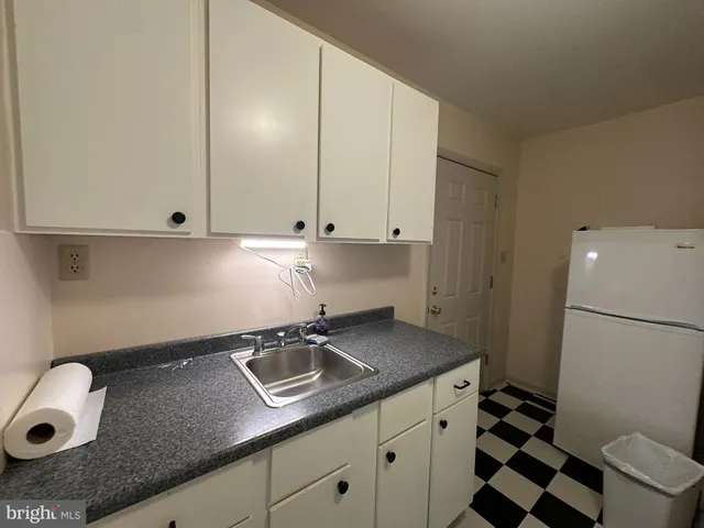 a view of a storage & utility room with a sink