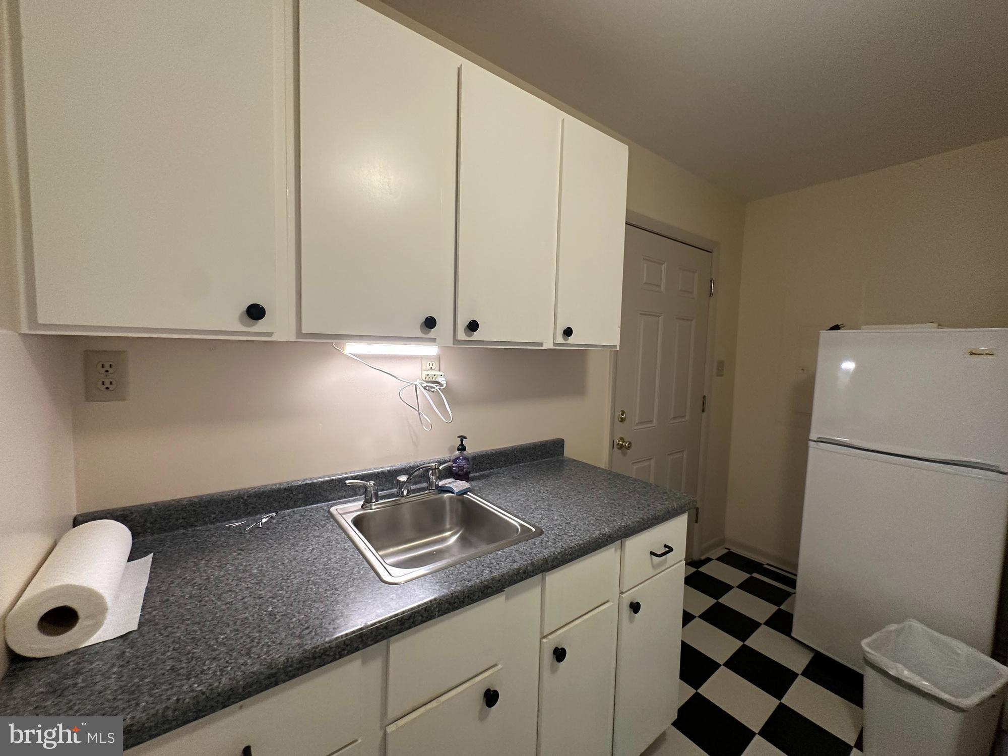 3 Delaware Avenue Delmar, DE 19940 - Photo 7 of 10 a kitchen with a sink and cabinets