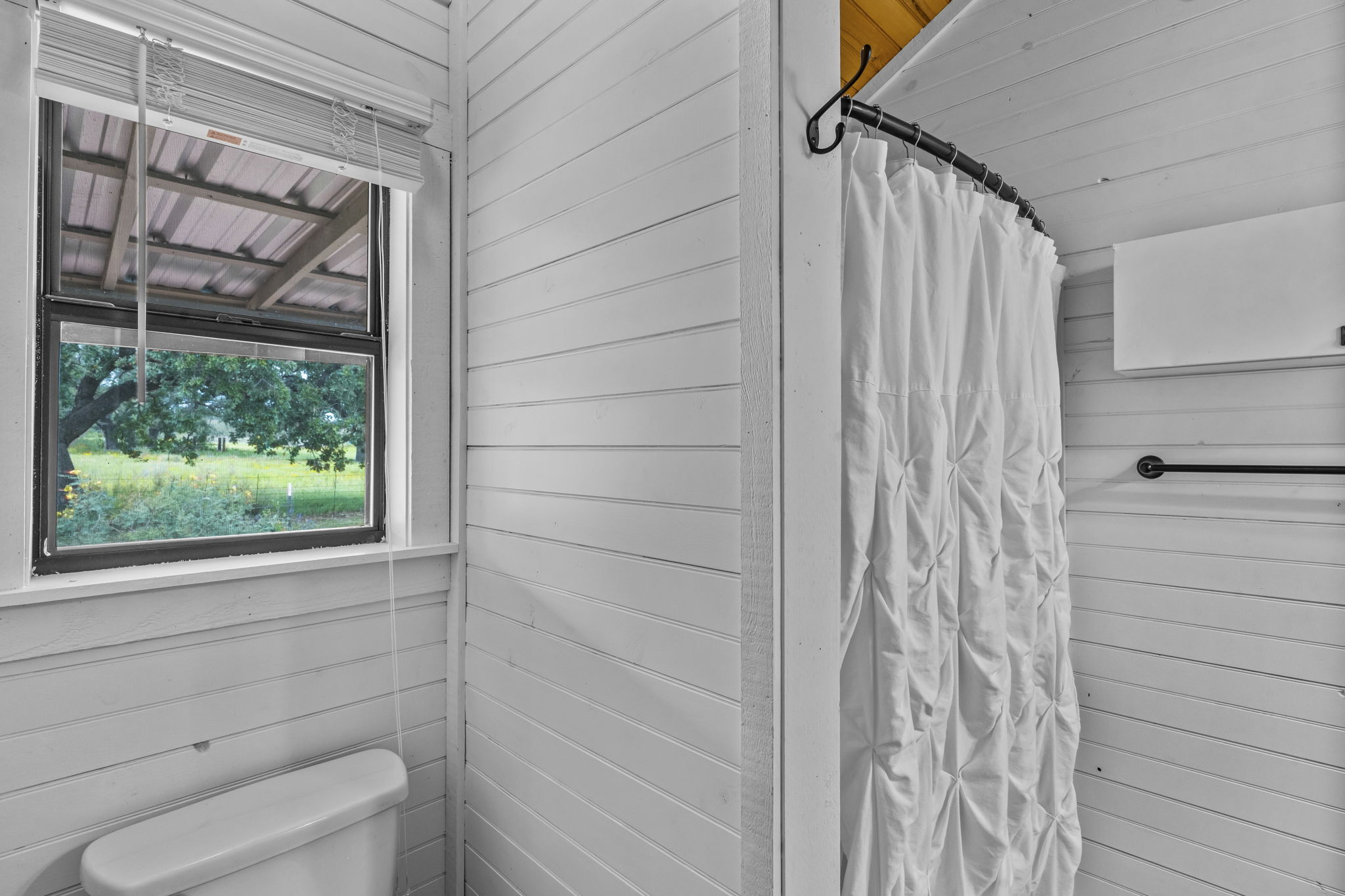 225 Ischar Lane Mason, TX 76856 - Photo 22 of 37 a bathroom with a toilet and a shower curtain