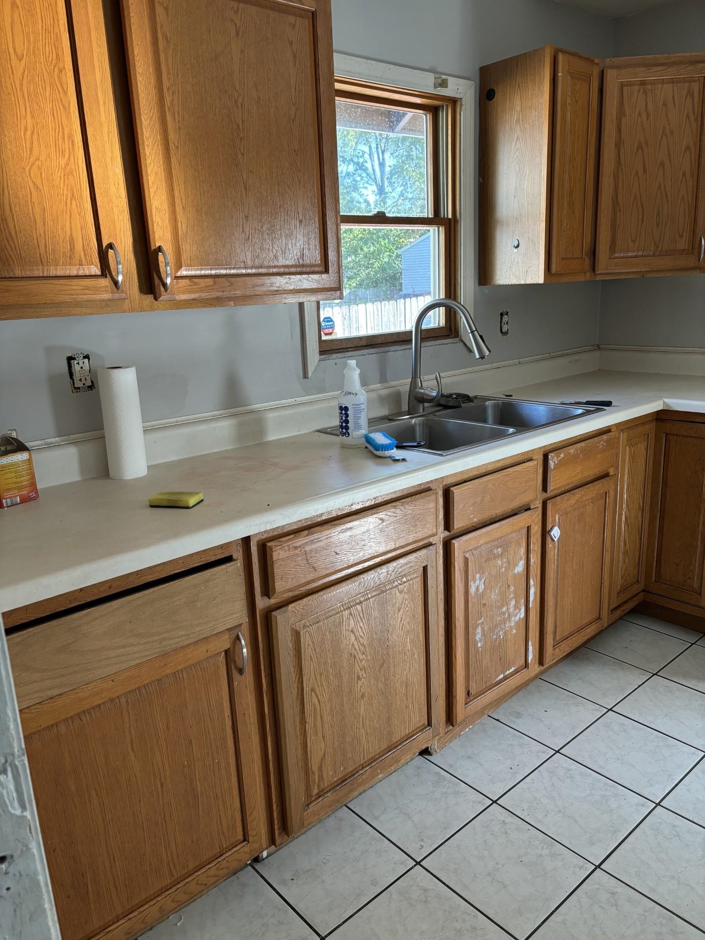 409 Barnum Road Rockford, IL 61109 - Photo 2 of 15 a kitchen with sink cabinets and window