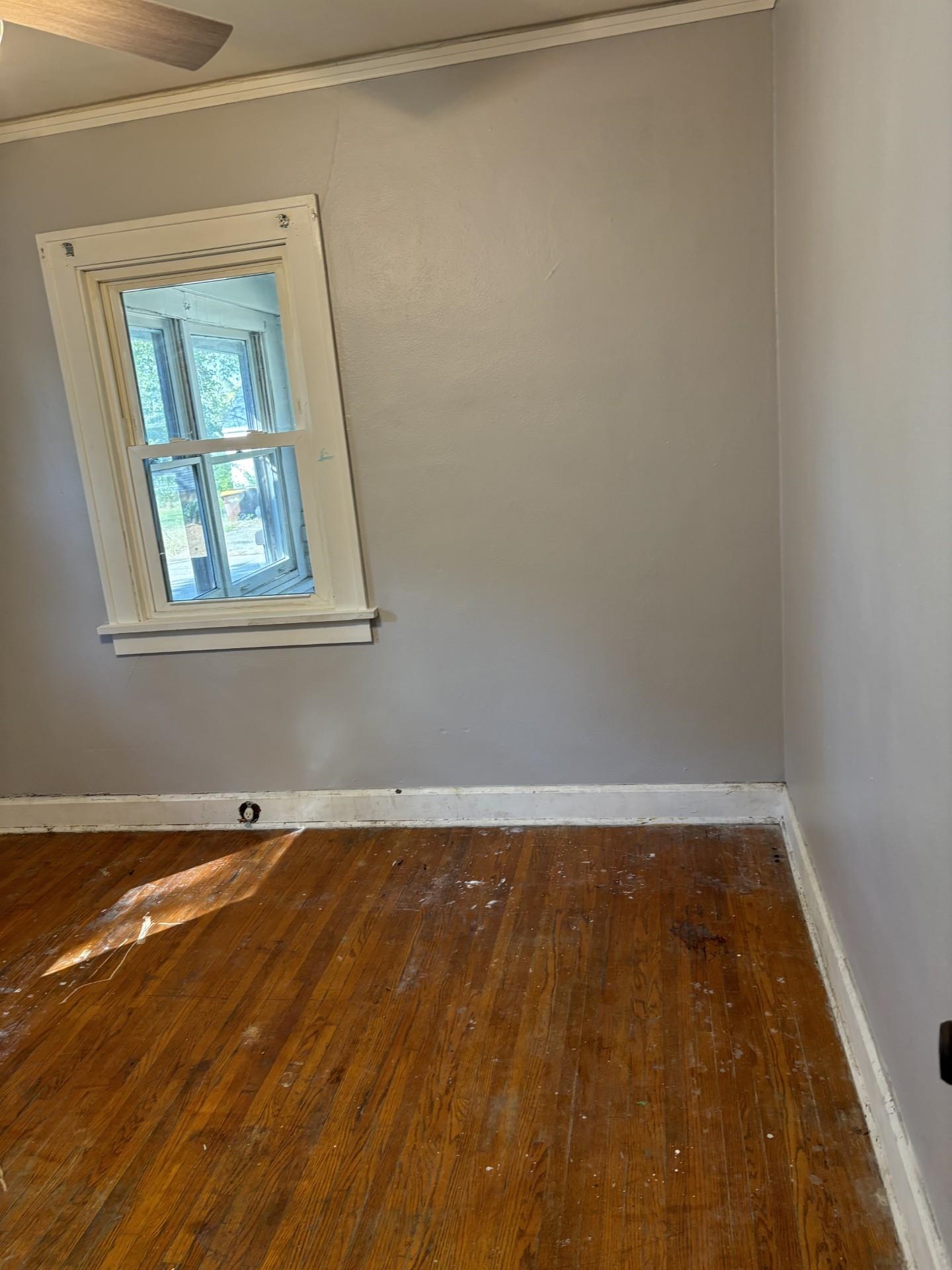 409 Barnum Road Rockford, IL 61109 - Photo 6 of 15 an empty room with wooden floor and windows