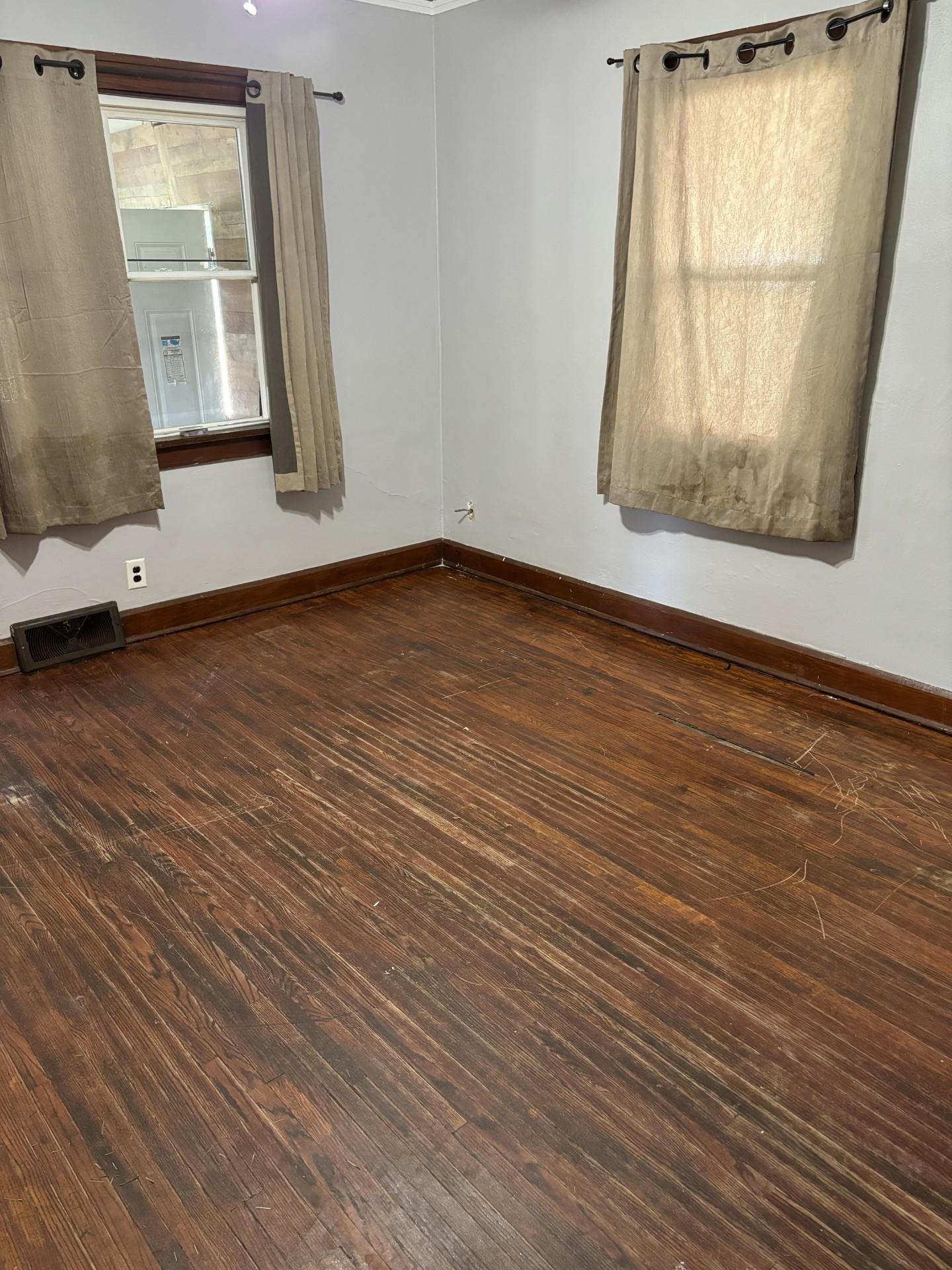 409 Barnum Road Rockford, IL 61109 - Photo 9 of 15 an empty room with wooden floor and windows