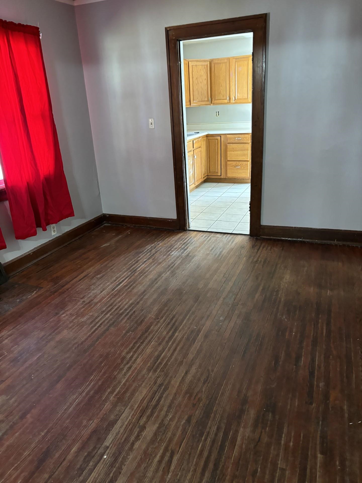 409 Barnum Road Rockford, IL 61109 - Photo 10 of 15 an empty room with wooden floor and door