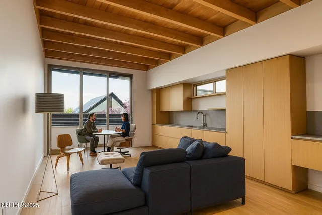 a living room with furniture a flat screen tv and a table