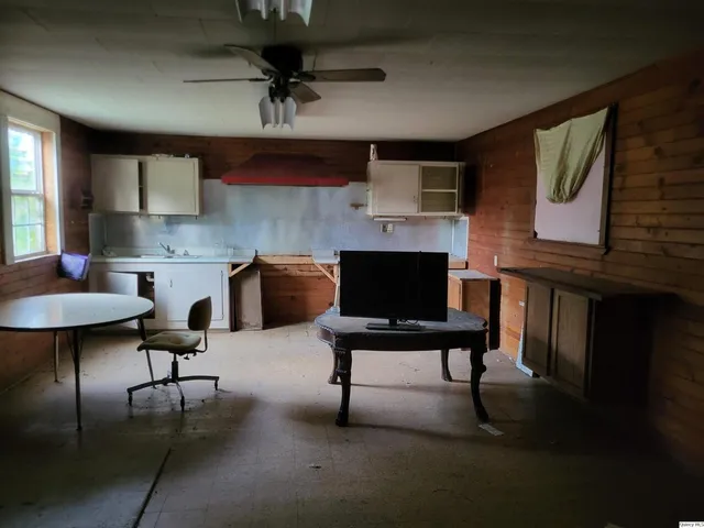 a living room with furniture a rug and a fireplace