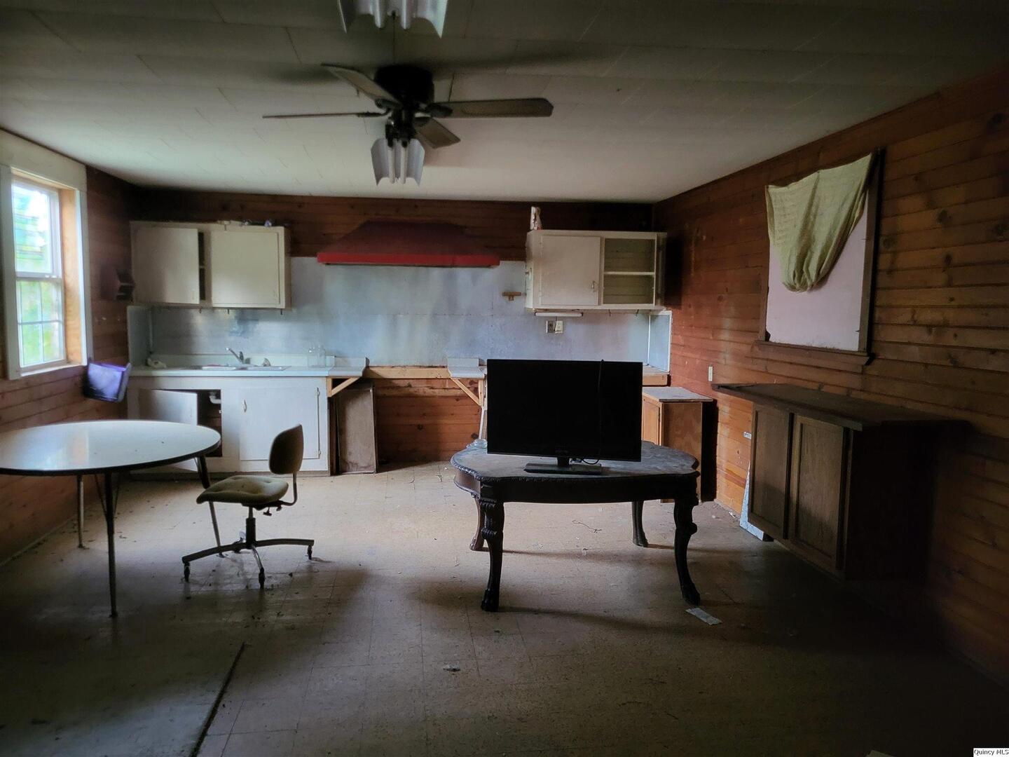 110 North Main Street Chambersburg, IL 62323 - Photo 3 of 7 a living room with furniture a rug and a fireplace