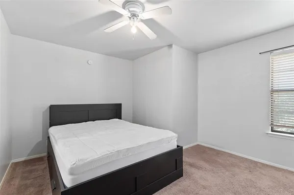 a room with a bed and a chandelier