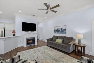 5608 Hollybrook Drive Tyler, TX 75703 - Photo 21 of 36 a living room with furniture a fireplace and a flat screen tv