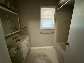 en empty room with window and hardwood floor