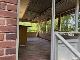 a view of a kitchen with wooden floor and a ceiling fan