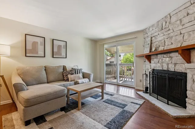 a living room with furniture a window and a fireplace