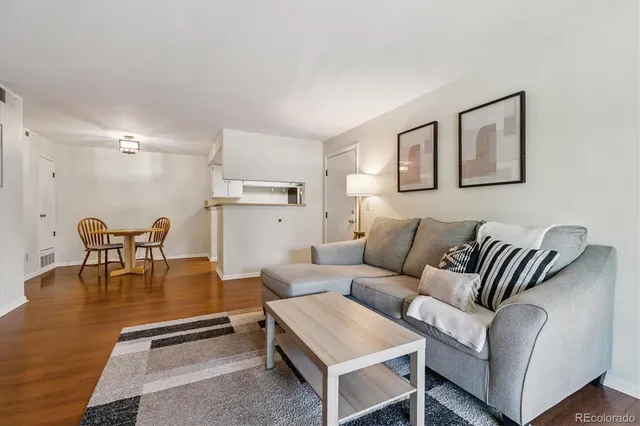 a living room with furniture and kitchen view