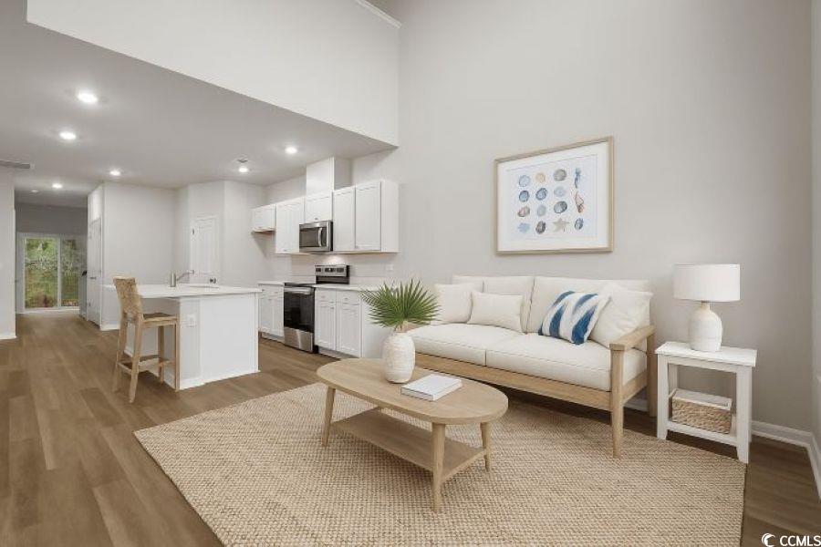 816 Palm Frond Way, Unit 41 Calabash, NC 28467 - Photo 13 of 35 Living room with light LVP flooring and recessed lighting furnished model not this homesite, representative photos