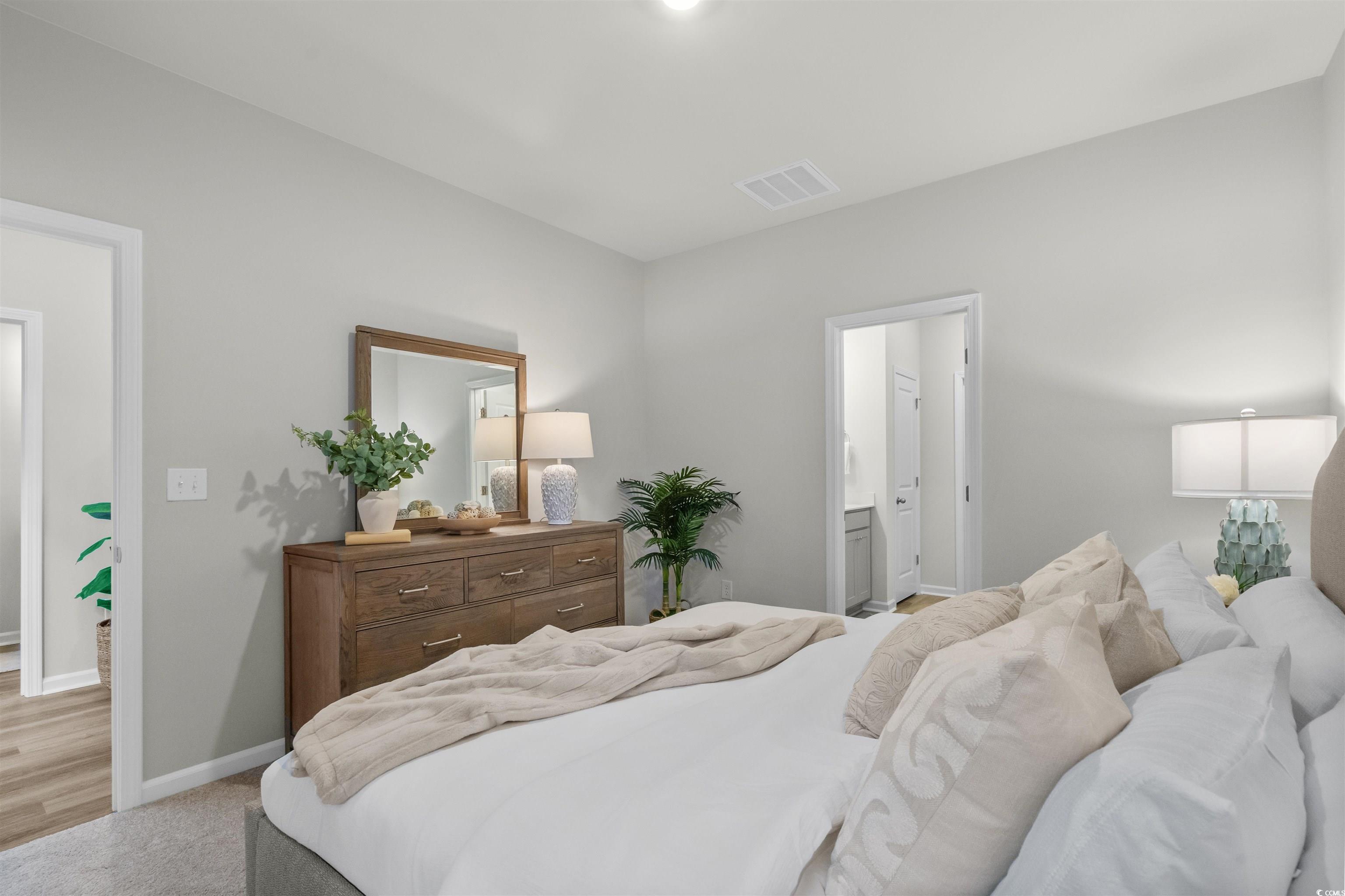 816 Palm Frond Way, Unit 41 Calabash, NC 28467 - Photo 17 of 35 Bedroom featuring light carpet and connected bathroom representative photos of our model, not this homesite