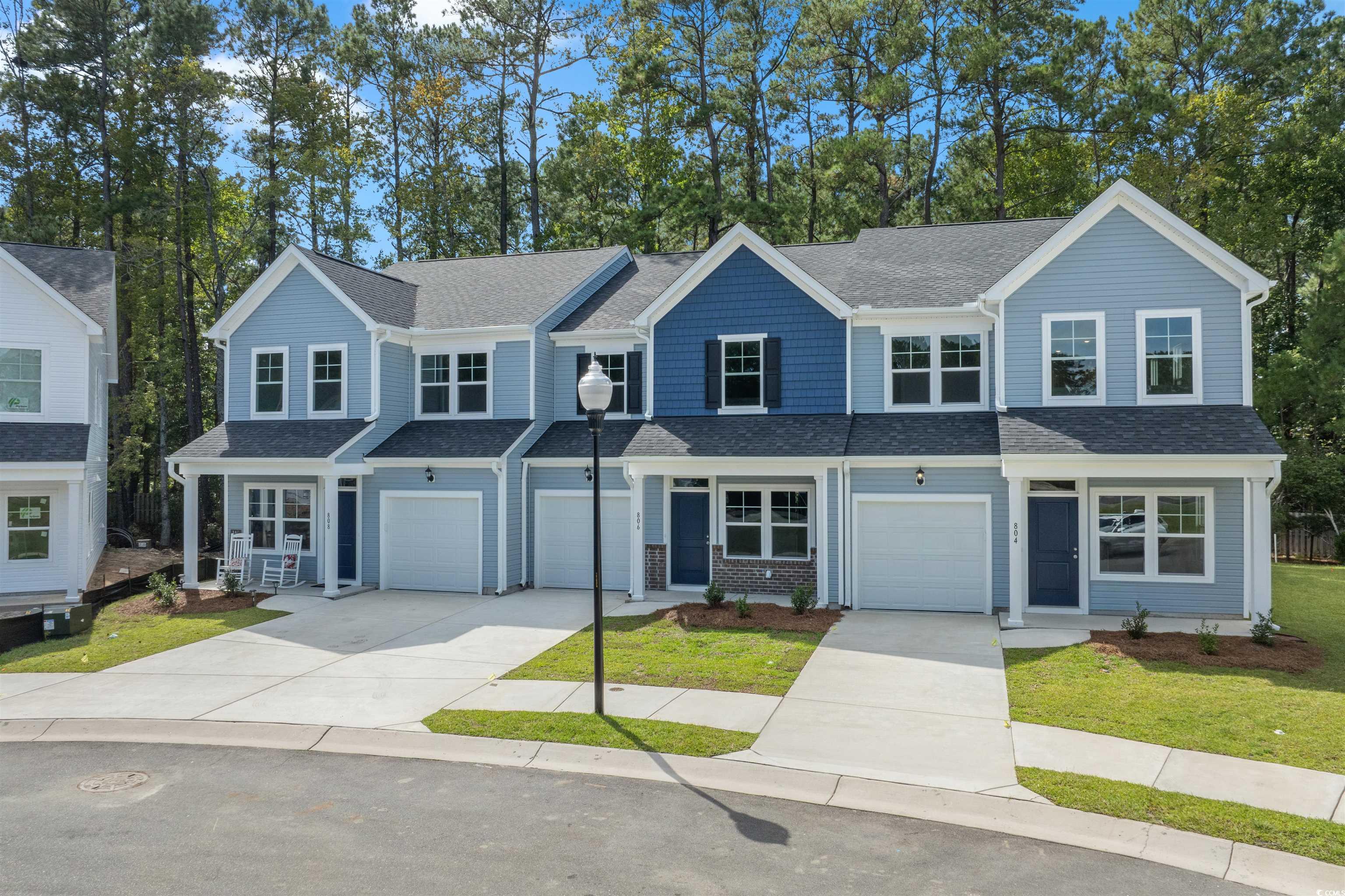 816 Palm Frond Way, Unit 41 Calabash, NC 28467 - Photo 25 of 35 Traditional home with driveway, a shingled roof, a front lawn, and an attached garage