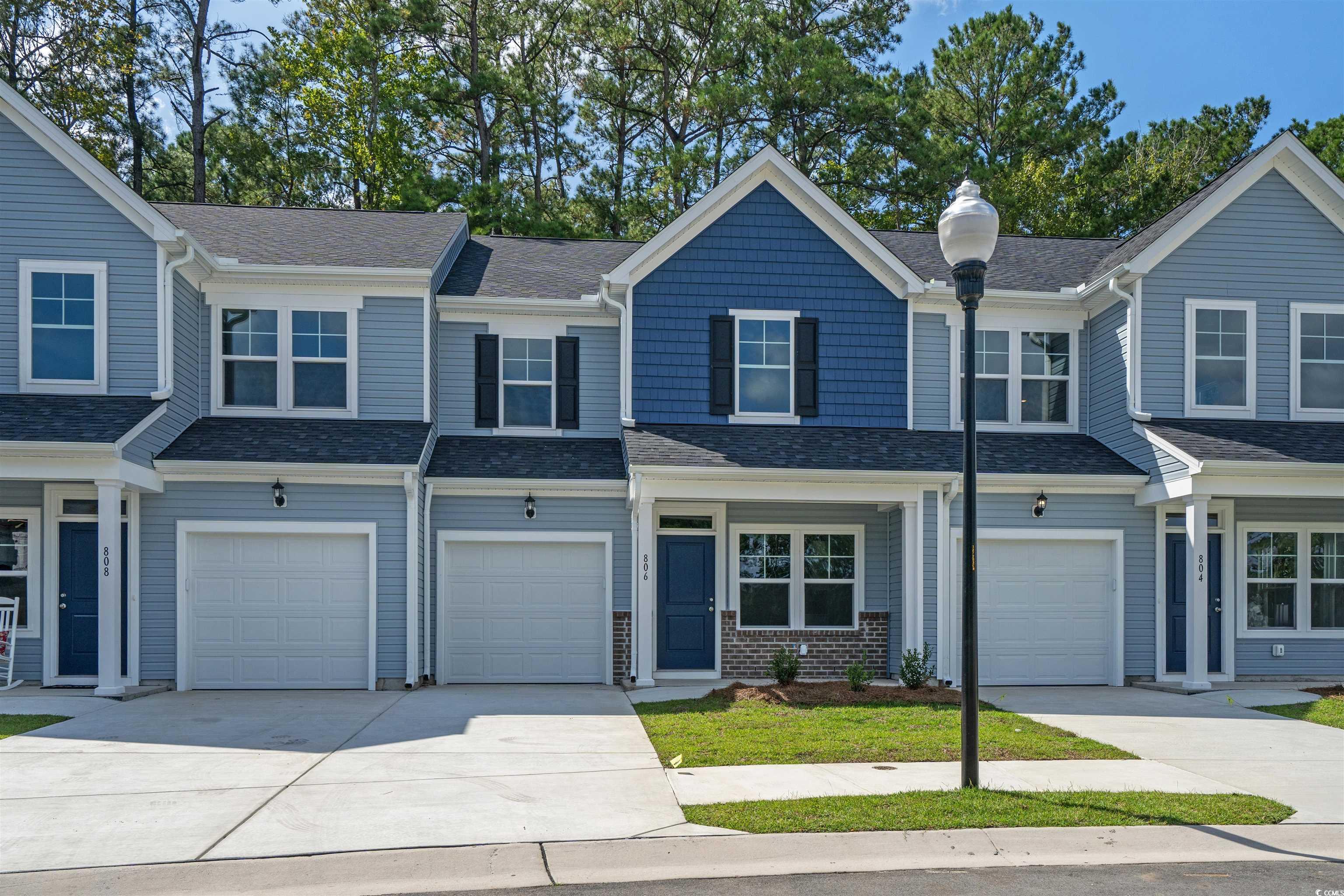816 Palm Frond Way, Unit 41 Calabash, NC 28467 - Photo 26 of 35 View of front facade with driveway, roof with shingles, and an attached garage
