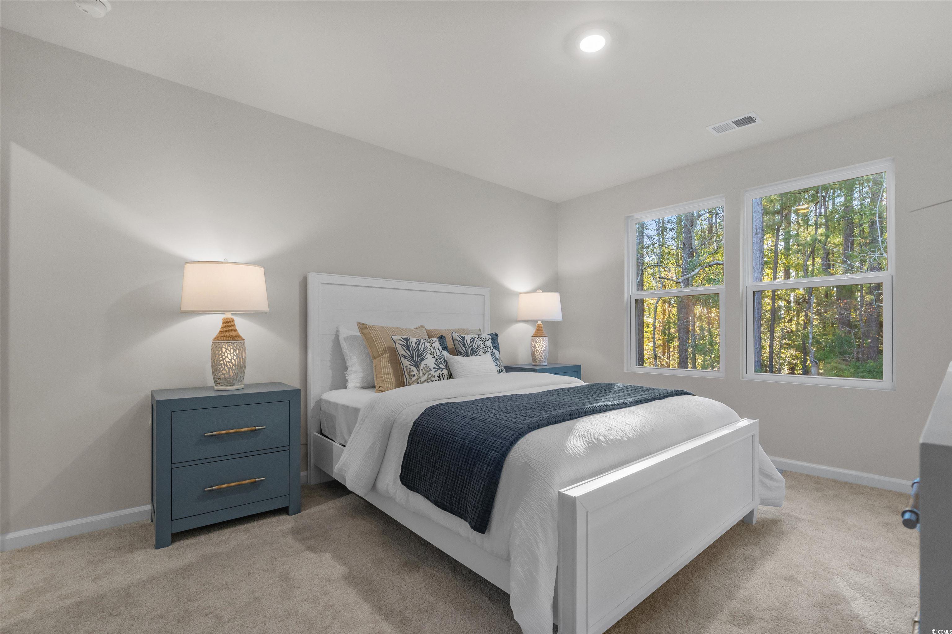 816 Palm Frond Way, Unit 41 Calabash, NC 28467 - Photo 27 of 35 Bedroom featuring light colored carpet with attached full bathroom, representative photos of our model, not this homesite