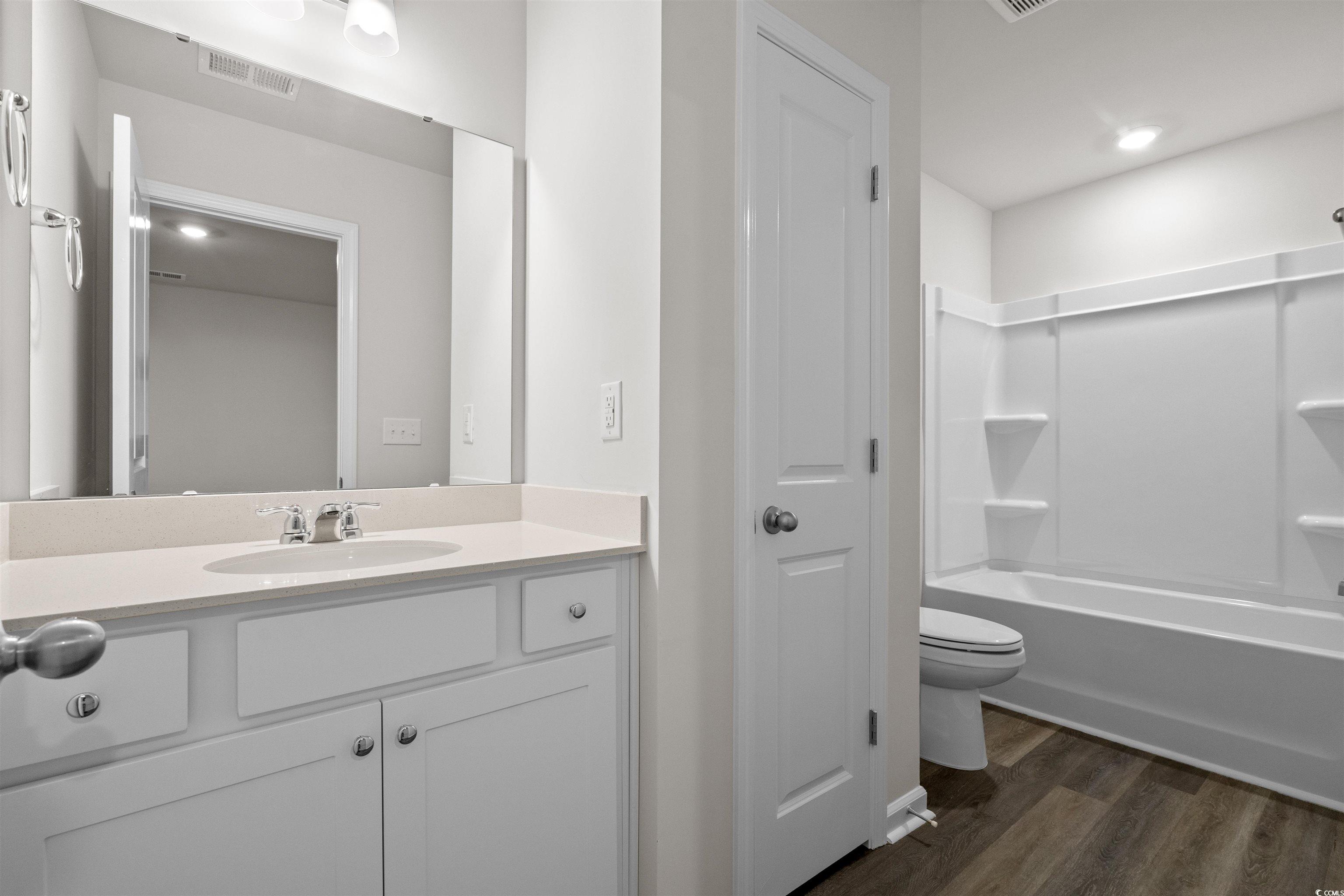 816 Palm Frond Way, Unit 41 Calabash, NC 28467 - Photo 30 of 35 Bathroom with vanity, LVP flooring, shower / tub combination, representative photos of our model, not this homesite