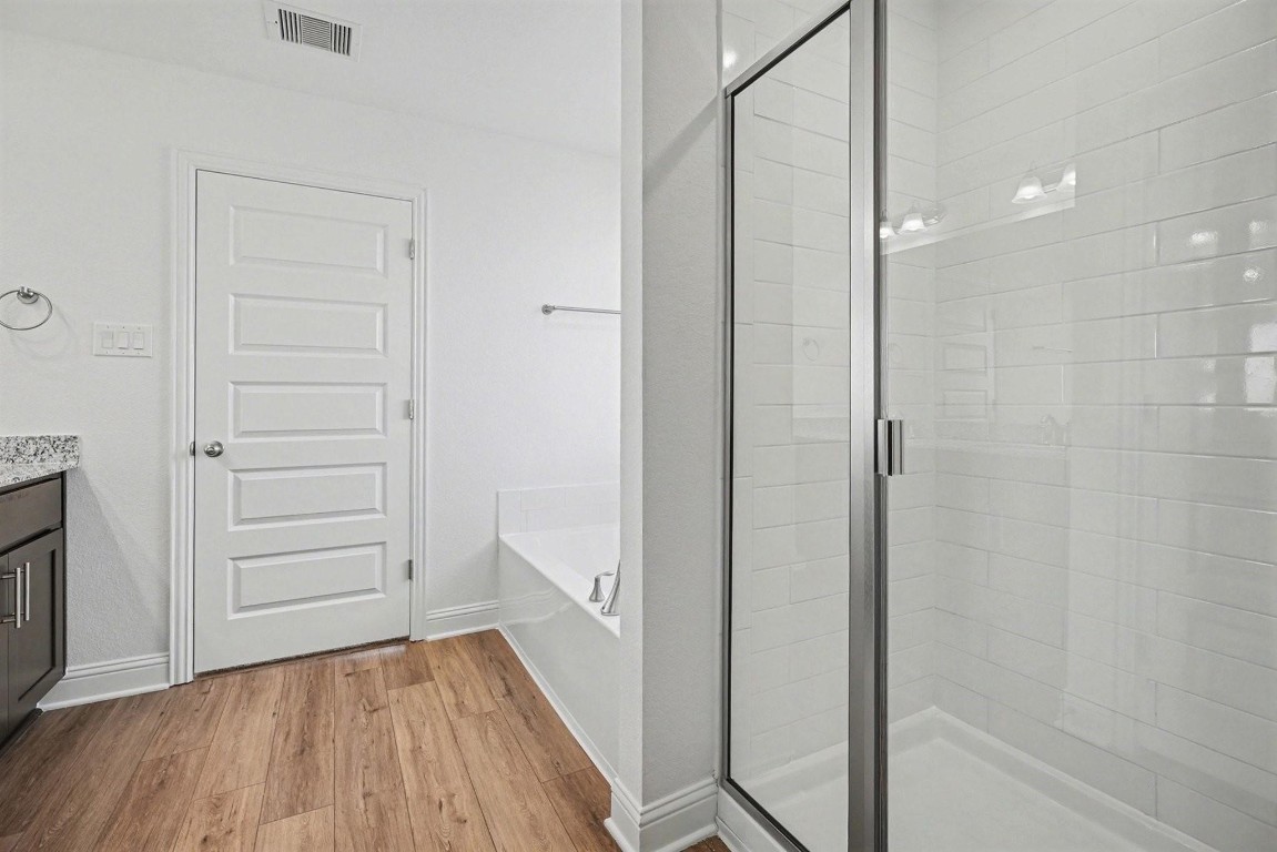 8 Gemstone Court Angleton, TX 77515 - Photo 6 of 7 a view of walk in closet with wooden floor