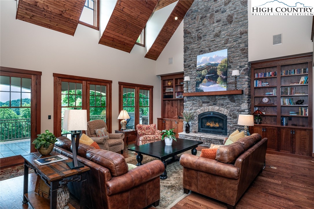 879 Winding Ridge Drive West Jefferson, NC 28694 - Photo 11 of 37 a living room with furniture a large window and a fireplace