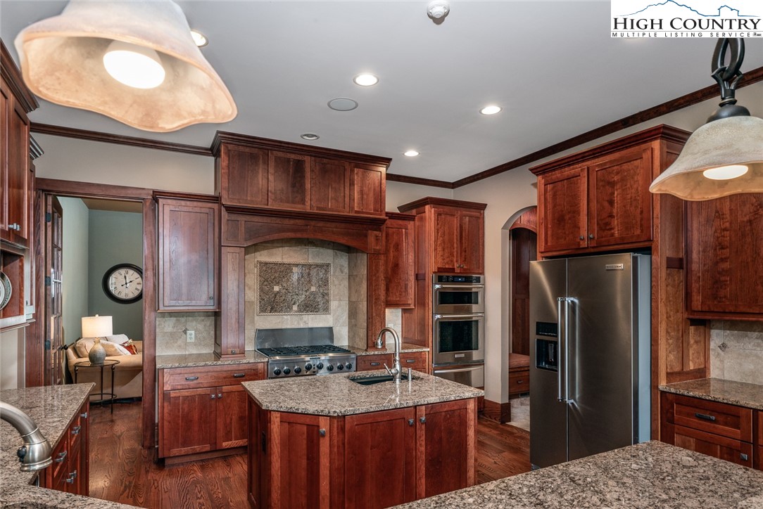 879 Winding Ridge Drive West Jefferson, NC 28694 - Photo 13 of 37 a kitchen with stainless steel appliances granite countertop a sink refrigerator and cabinets