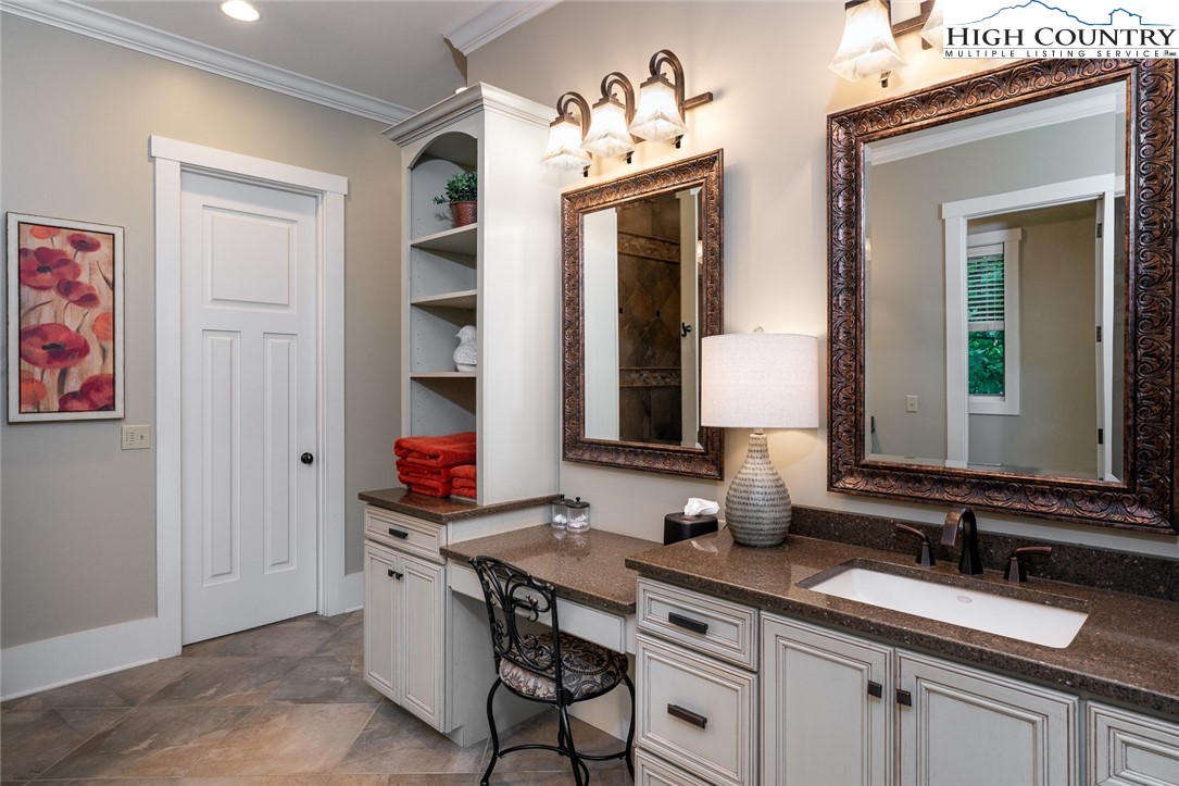 879 Winding Ridge Drive West Jefferson, NC 28694 - Photo 19 of 37 a bathroom with a granite countertop sink and a mirror