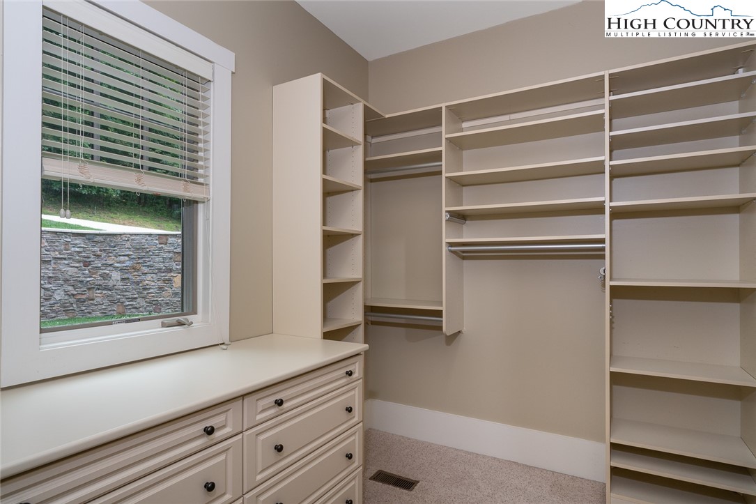 879 Winding Ridge Drive West Jefferson, NC 28694 - Photo 21 of 37 a view of walk in closet with empty racks