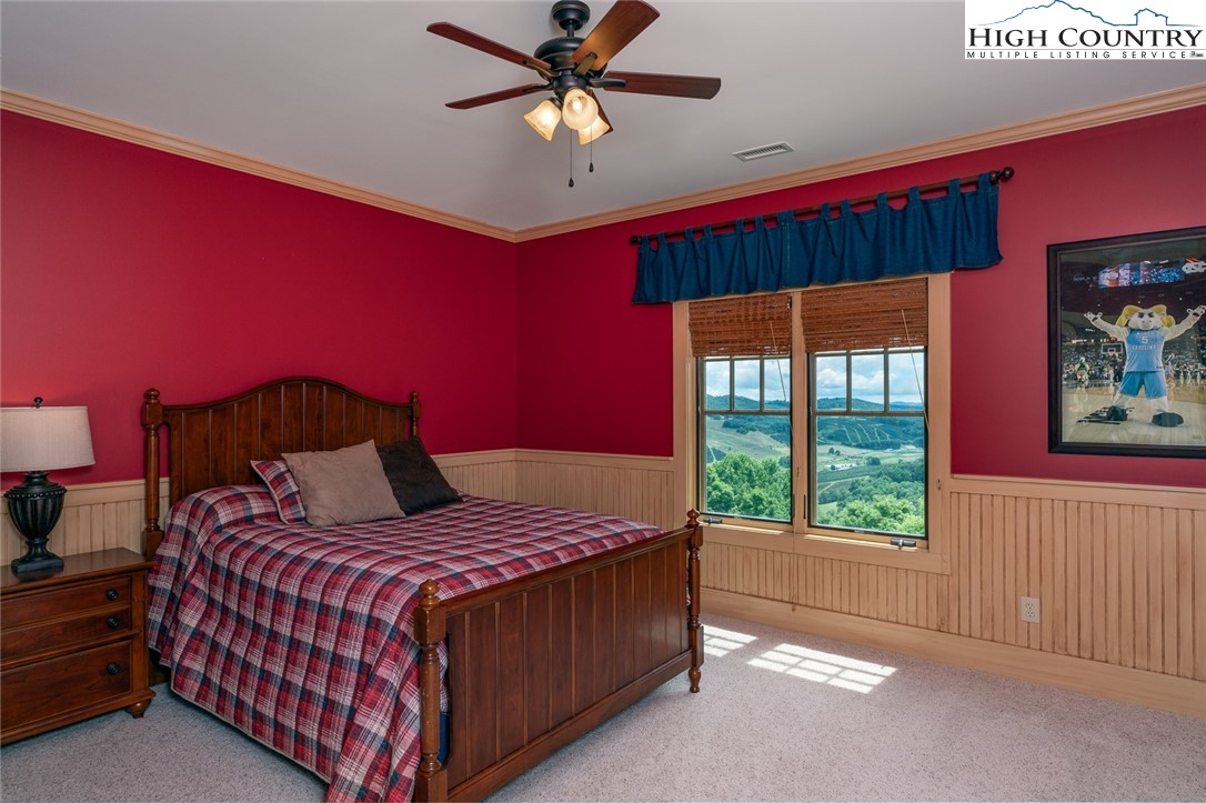 879 Winding Ridge Drive West Jefferson, NC 28694 - Photo 22 of 37 a bedroom with a bed and a window
