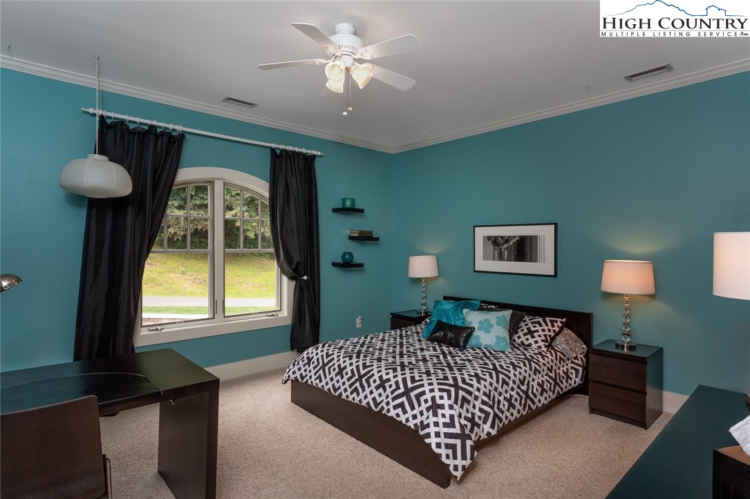 879 Winding Ridge Drive West Jefferson, NC 28694 - Photo 22 of 37 a bedroom with a bed and a window