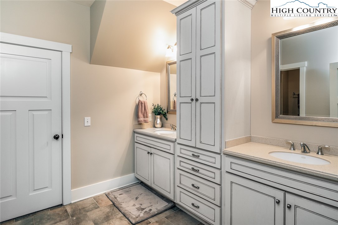 879 Winding Ridge Drive West Jefferson, NC 28694 - Photo 23 of 37 a bathroom with a sink and a mirror