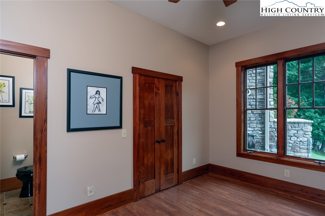 879 Winding Ridge Drive West Jefferson, NC 28694 - Photo 29 of 37 an empty room with wooden floor and windows